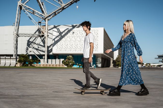Couple walking near modern building