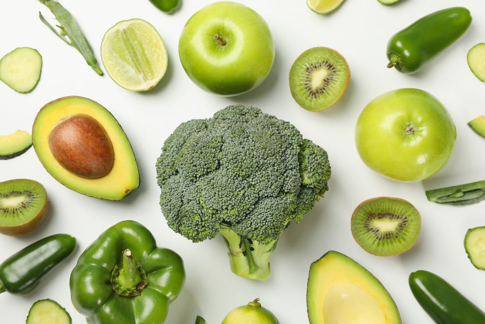 Green vegetables and fruits on blank background