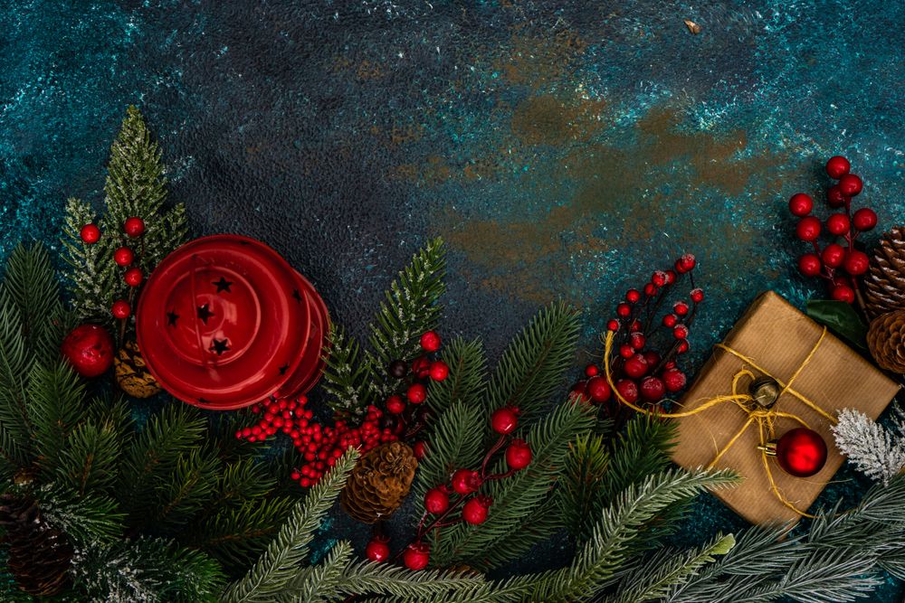 Top view of table with fir, holly, pine and Christmas gifts and ornaments