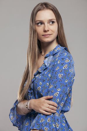 Blonde female with floral shirt posing in studio