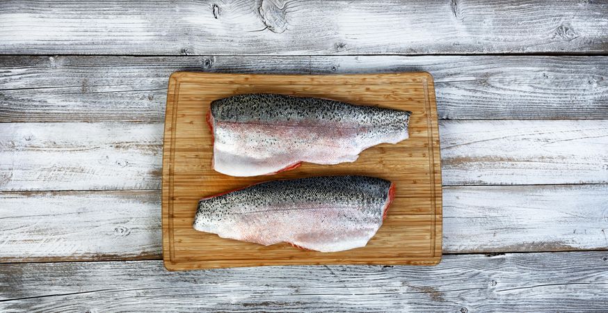 Rainbow trout fillet on bamboo cutting board