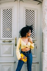 Fashionable Black female by gray door