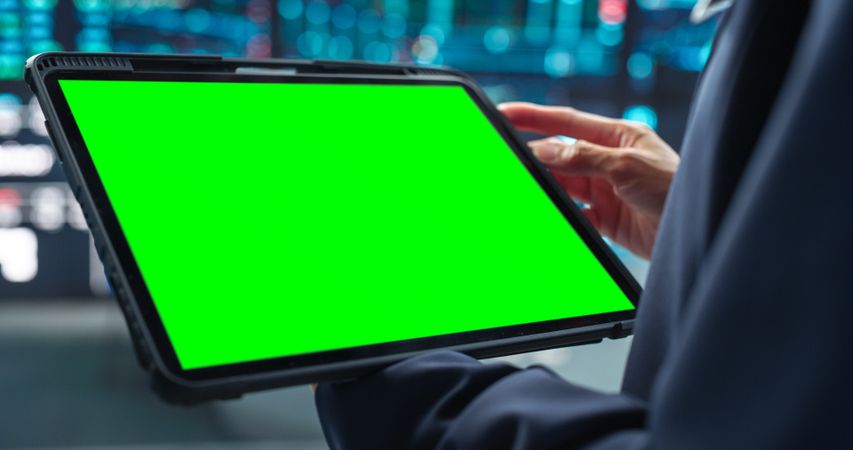 Person Holding a Tablet Computer with Green Screen Mock Up Display.