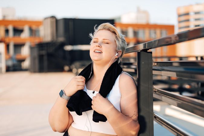 Woman with towel on neck after a workout outside