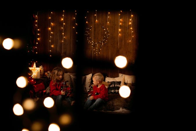 Siblings playing in a room with christmas decoration