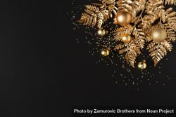 Golden holiday decorations, glitter, baubles and leaves on dark background 41R2Nb
