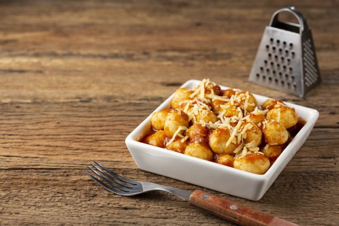 Gnocchi with tomato sauce and grated Parmesan cheese.