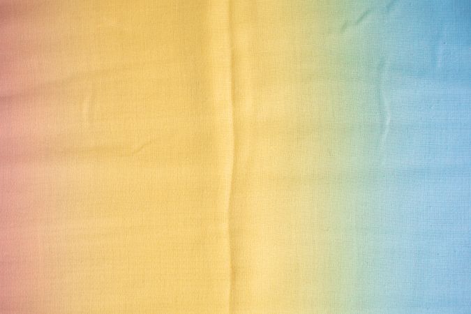Gradient yellow blue pink and green fabric  background texture.