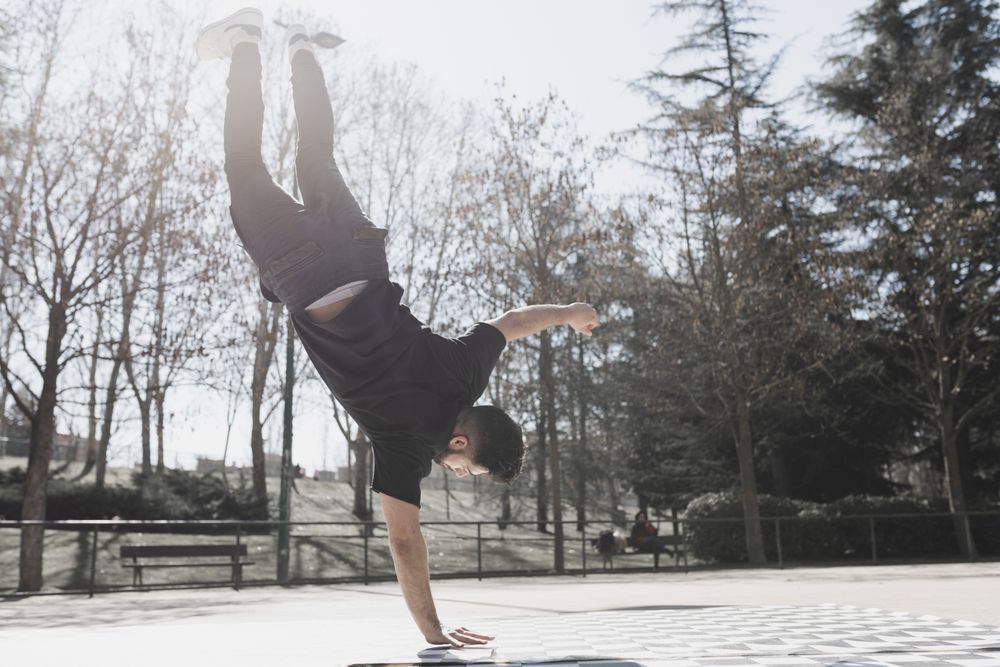 Man dancing break dance in park
