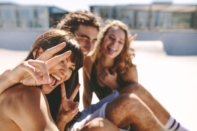 Playful friends taking silly selfie outdoors