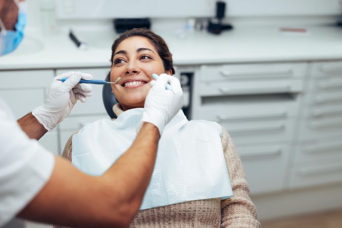 Woman getting a dental treatment at dentist office