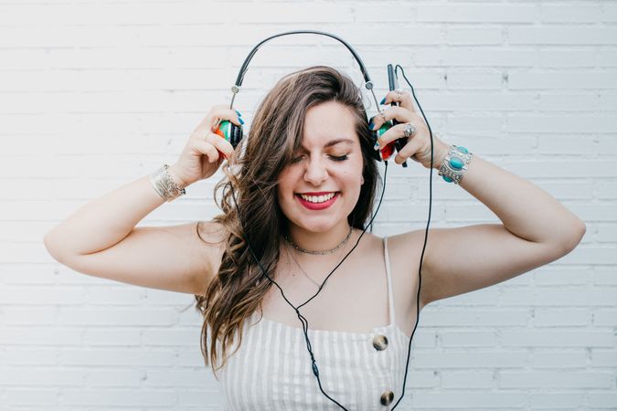 Woman in bright headphones listening to music