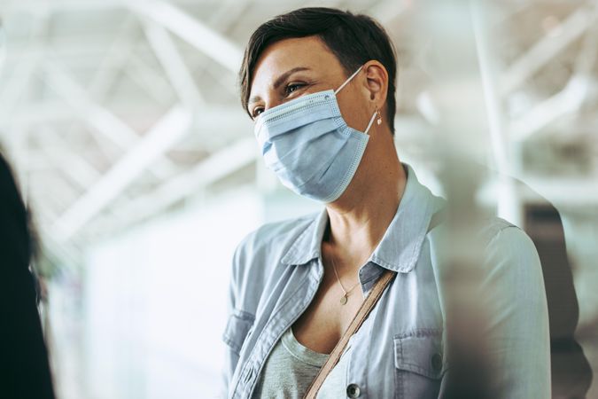 Woman traveler wearing face mask at airport