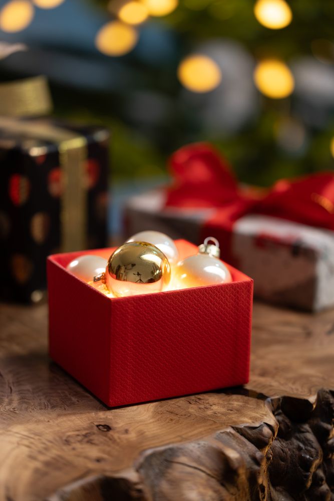 Christmas box with glowing ornaments