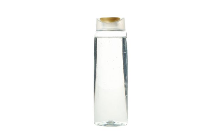 Blank plastic shampoo or lotion bottle isolated on light background