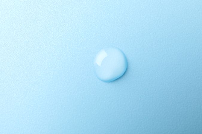 Drop of water in light blue room