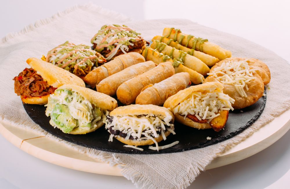 Venezuelan food tasting dish, the dish has arepas, tequeños, yuca and patacones