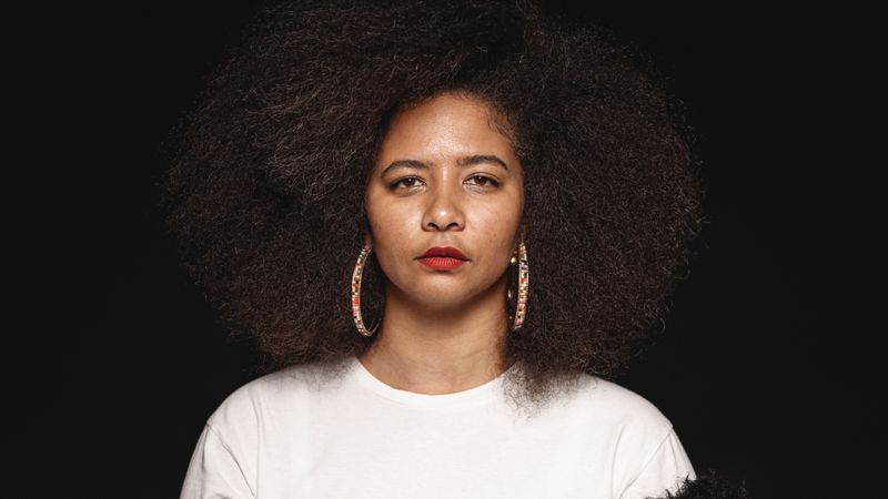 Woman in afro hairstyle isolated on dark background