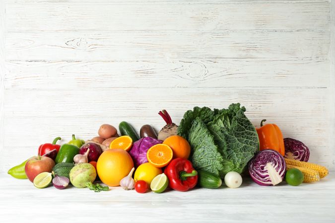 Vegetables and fruits on wooden background, copy space
