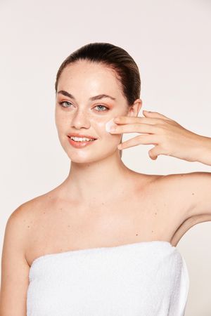 Amiable female taking care of face