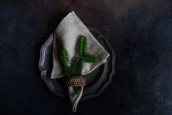 Holiday table setting with fir in napkin