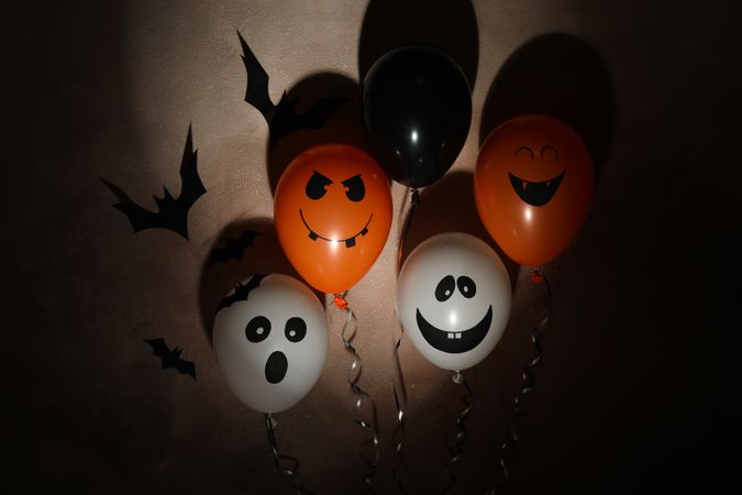 Different balloons on dark background. Halloween concept