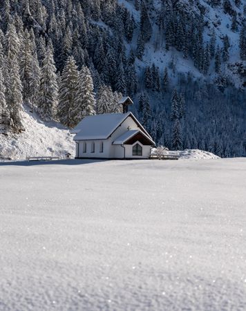 Church minimalist in a winter scenery with deep snow nature in the Bavarian Alps, Germany