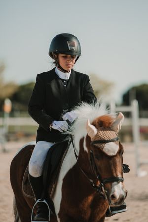 Teen girl riding horse