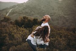 Affectionate couple having fun on hilly valley