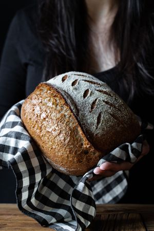 Crop person holding some bread