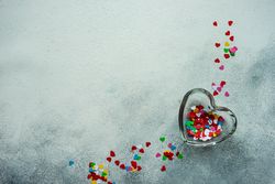 Colorful heart glitter in heart container