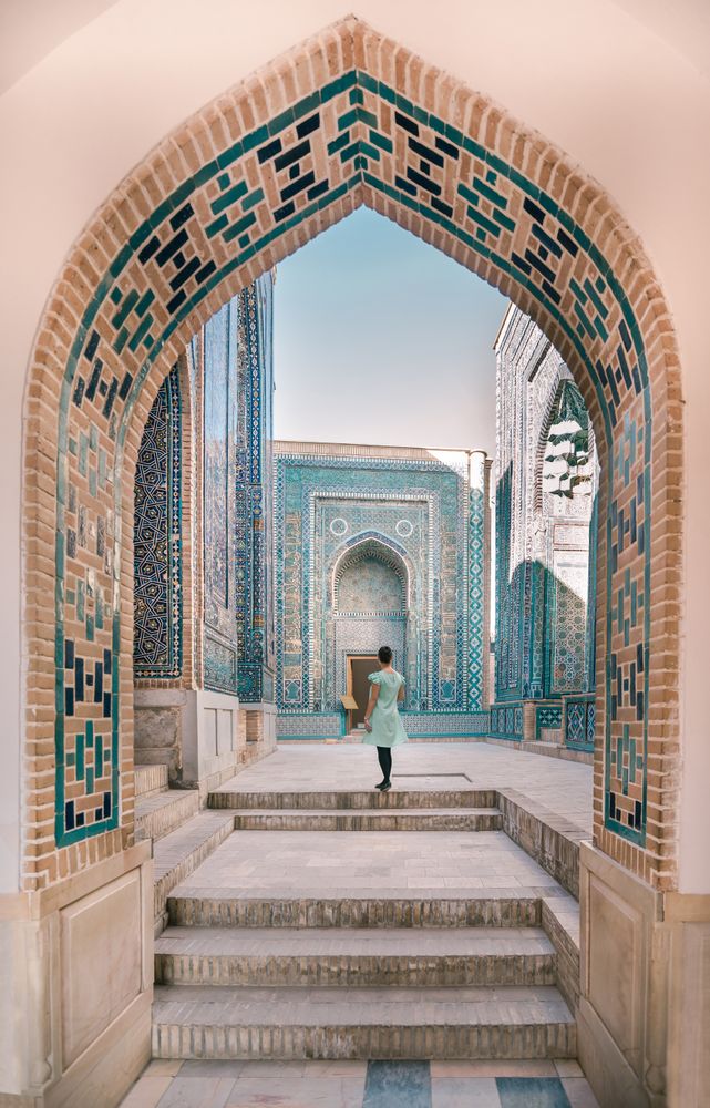 Woman walking in old archway