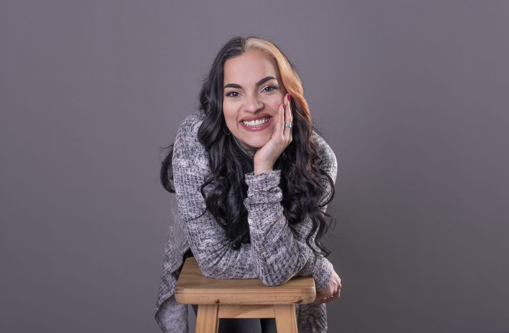 woman looking at camera with hands on face.