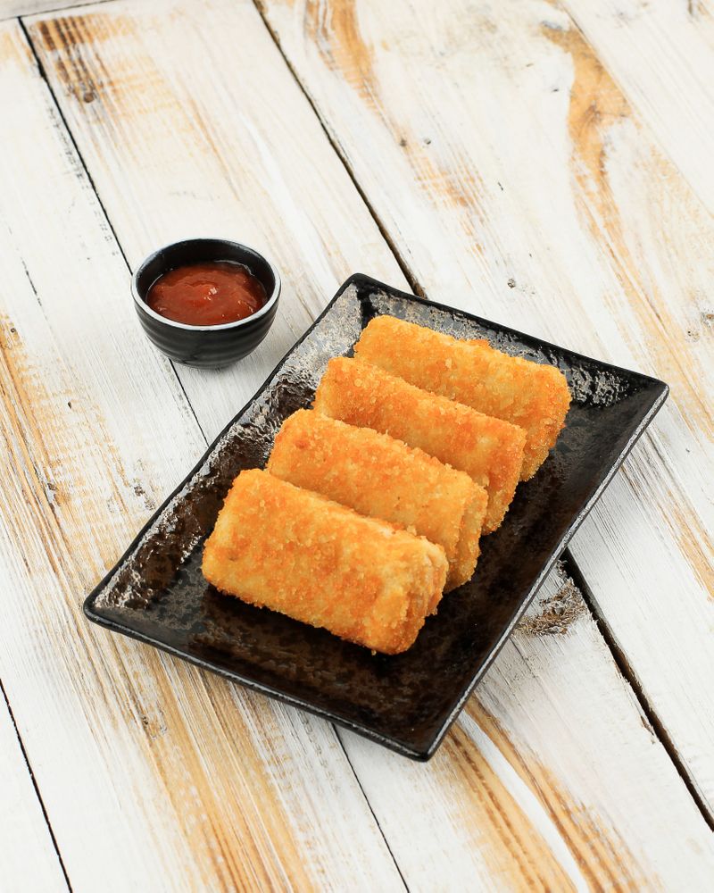 Pile of risol mayo keju, thin crepes rolled with egg and chicken inside