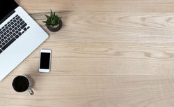 Desktop table with mobile devices and coffee