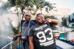 London, England, United Kingdom - August 27, 2022: Older man and young woman posing at food stall