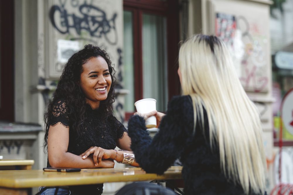 Friends talking in street cafe