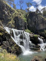 Waterfall among rocks on bright day