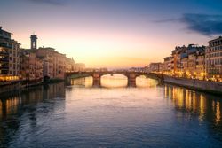 Old bridge across channel in sunset