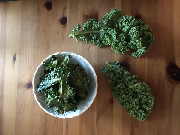 A bowl of kale on wooden table