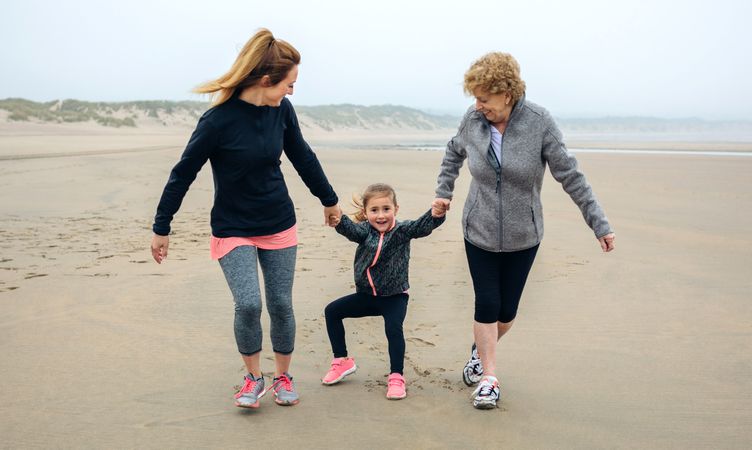 Three generations running on the beach
