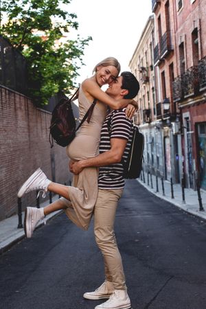 Happy couple having fun while walking in town