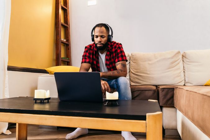 Black man making work video call with laptop at home