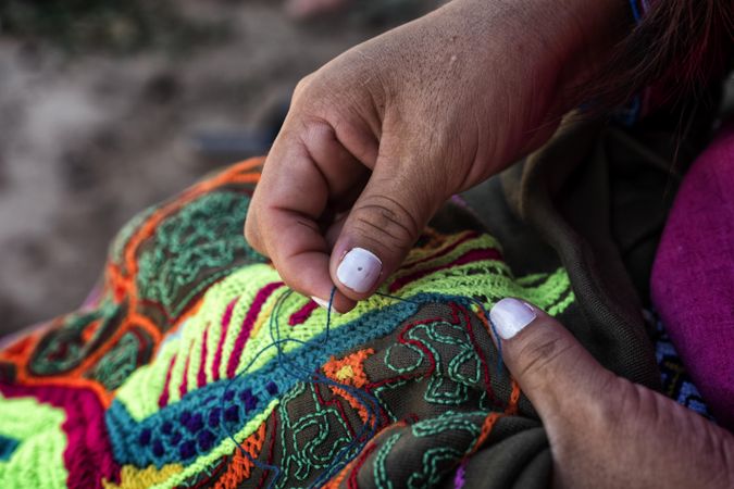 Person making colorful Peruvian embroidery