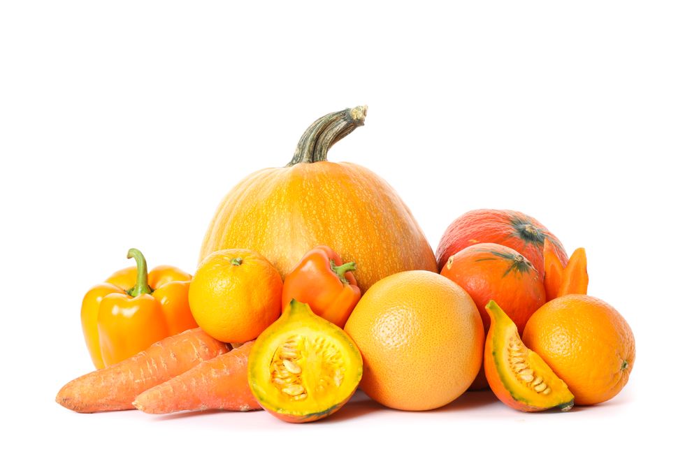 Pumpkins, oranges, carrot and peppers isolated on plain background