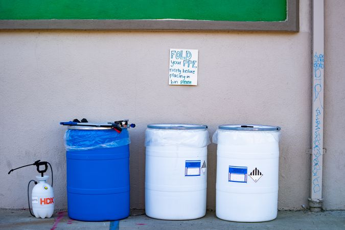 Three biohazard bins for PPE at public  COVID-19 test site