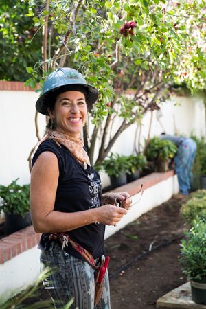 Female contractor smiling in garden