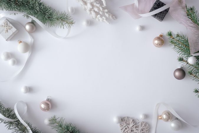 Winter branches and decorations on pastel grey background