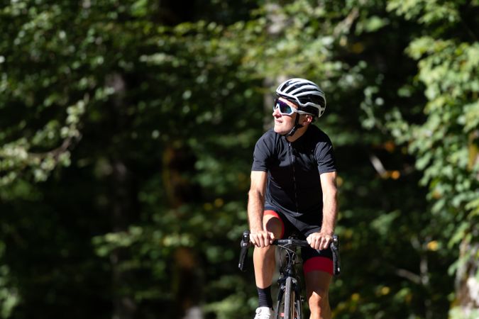 Professional cyclist riding bike in park