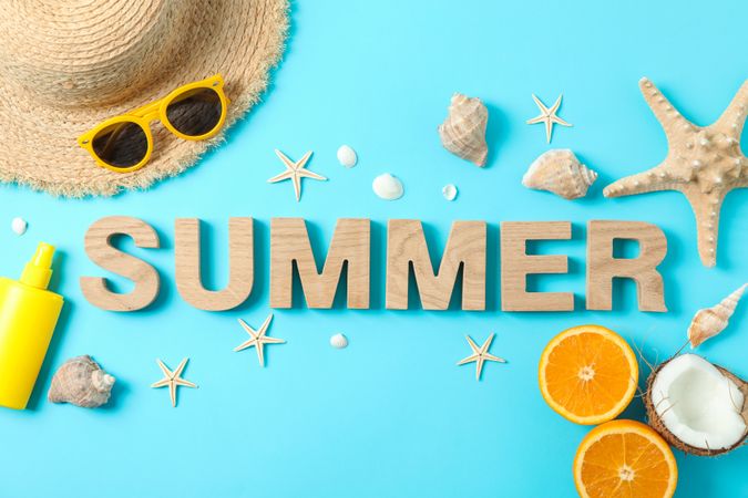 Inscription summer with starfishes, oranges, coconut, straw hat, sunscreen and sunglasses on color background, space for text. Happy holidays